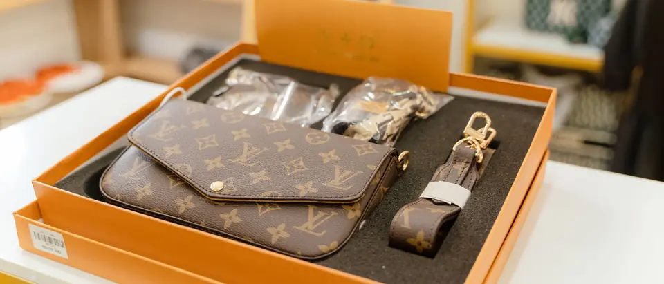 A Louis Vuitton Multi Pochette set in its orange presentation box