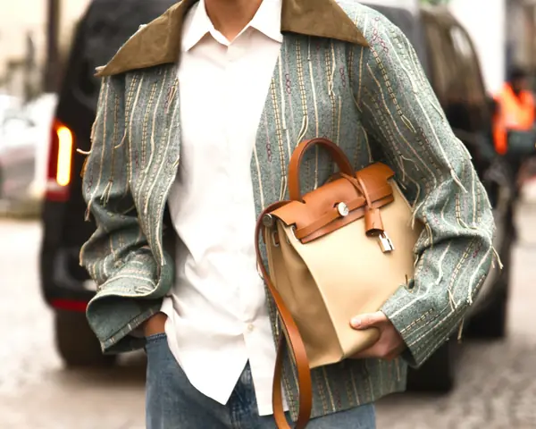 A pink Hermes Birkin standing in front of an orange Hermes box