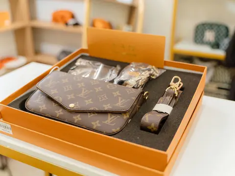 A Louis Vuitton Multi Pochette set in its orange presentation box